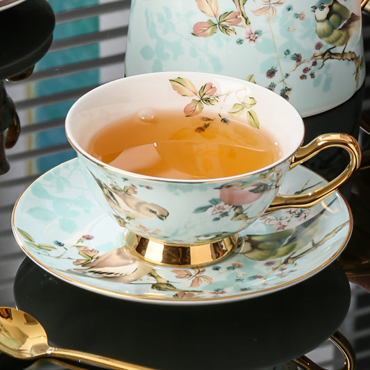 Elegant Bone Porcelain Tea Set with Golden Trim: Featuring a Cozy Cup, Saucer, and Spoon, Perfect for Sipping Your Favorite Tea. Hand Wash Only. Lead-Free and Insulated. Suitable for All Occasions.